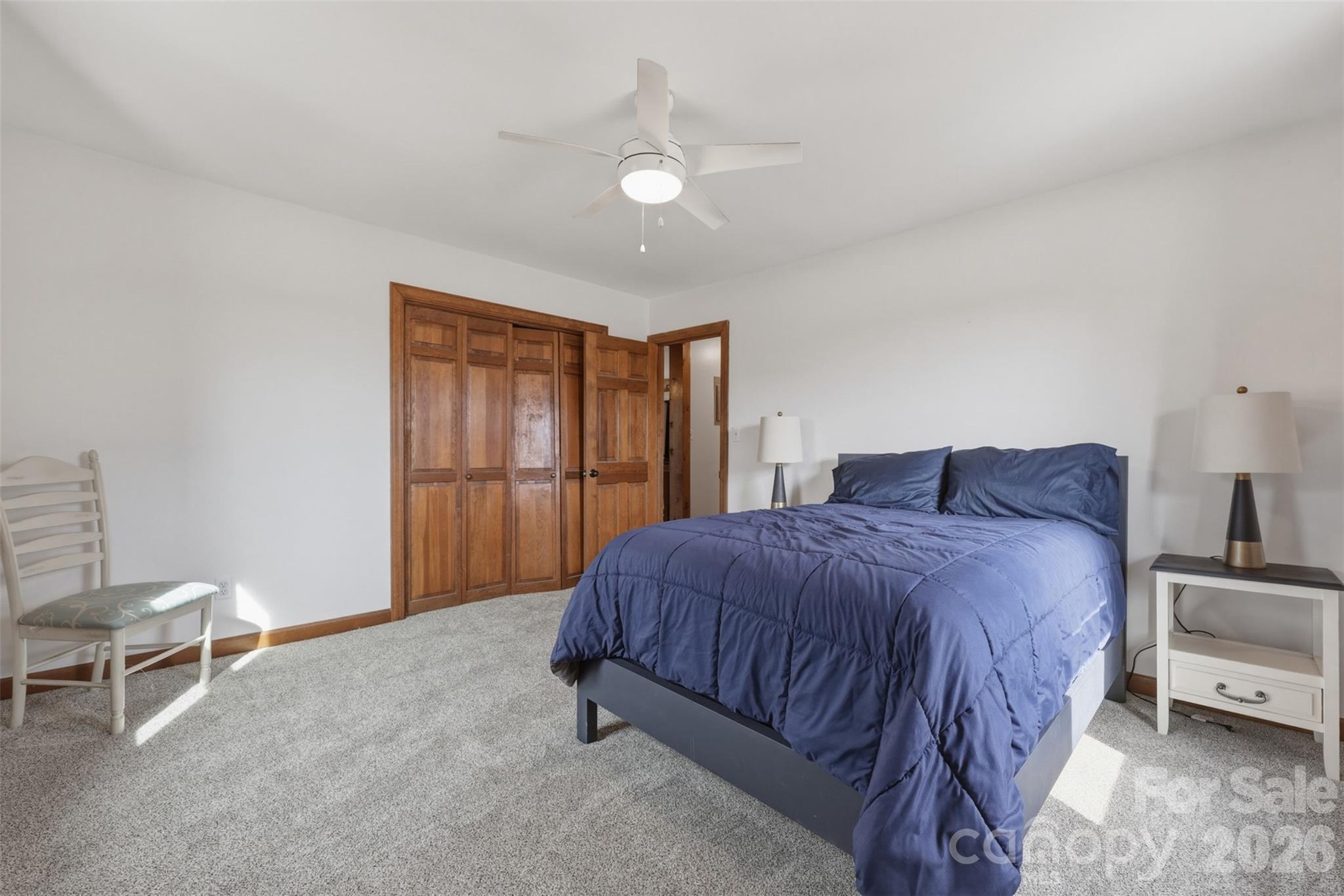 2255 Mt Olive Church Road Newton, NC 28658 - Photo 22 of 43 a spacious bedroom with a bed and a chair