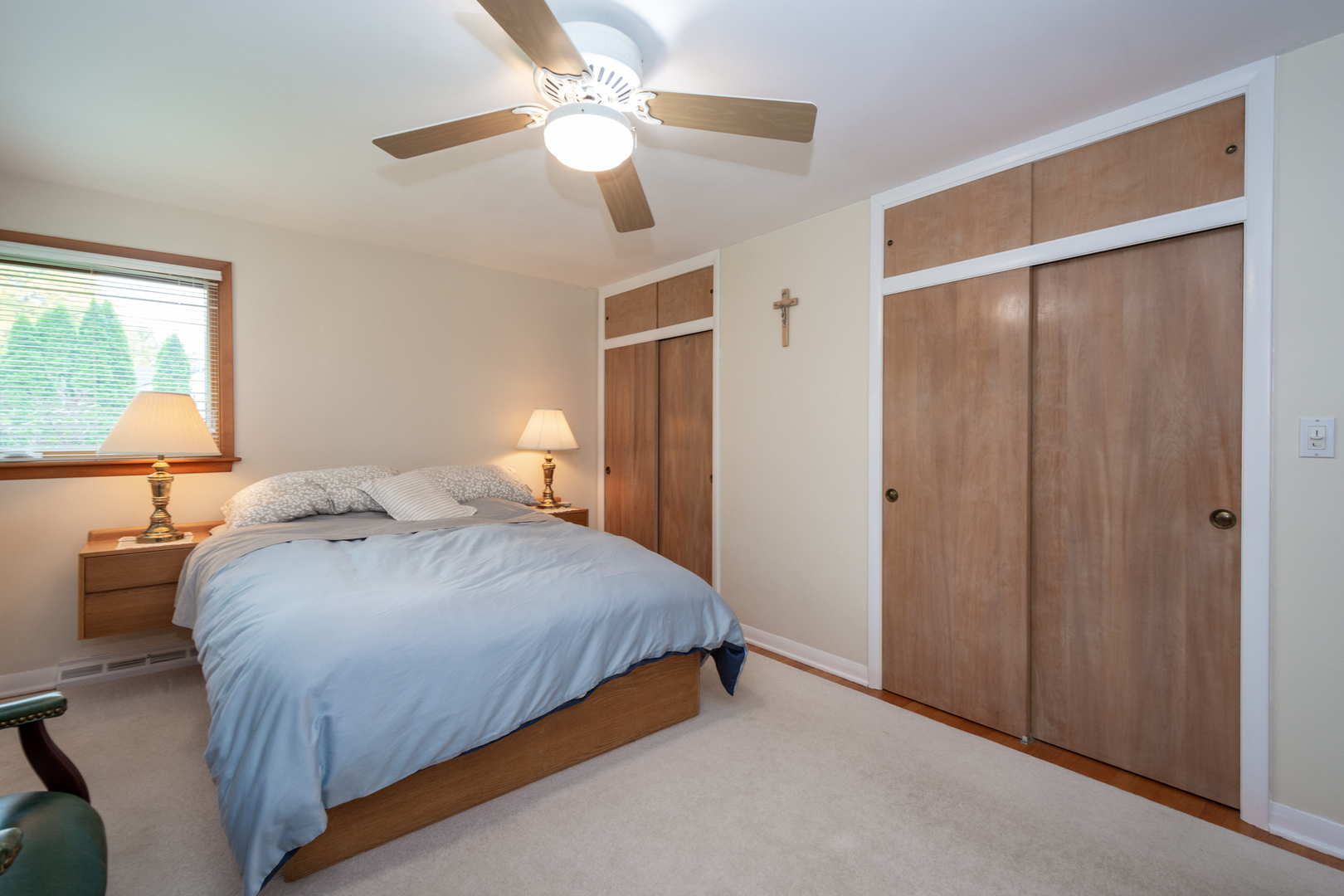 1420 Lee Road Northbrook, IL 60062 - Photo 13 of 36 a bedroom with a large bed and a chandelier