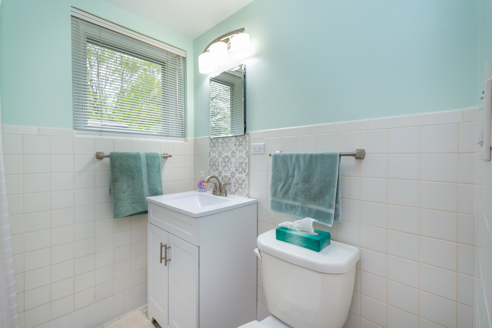 1420 Lee Road Northbrook, IL 60062 - Photo 20 of 36 a bathroom with a sink a toilet and a mirror