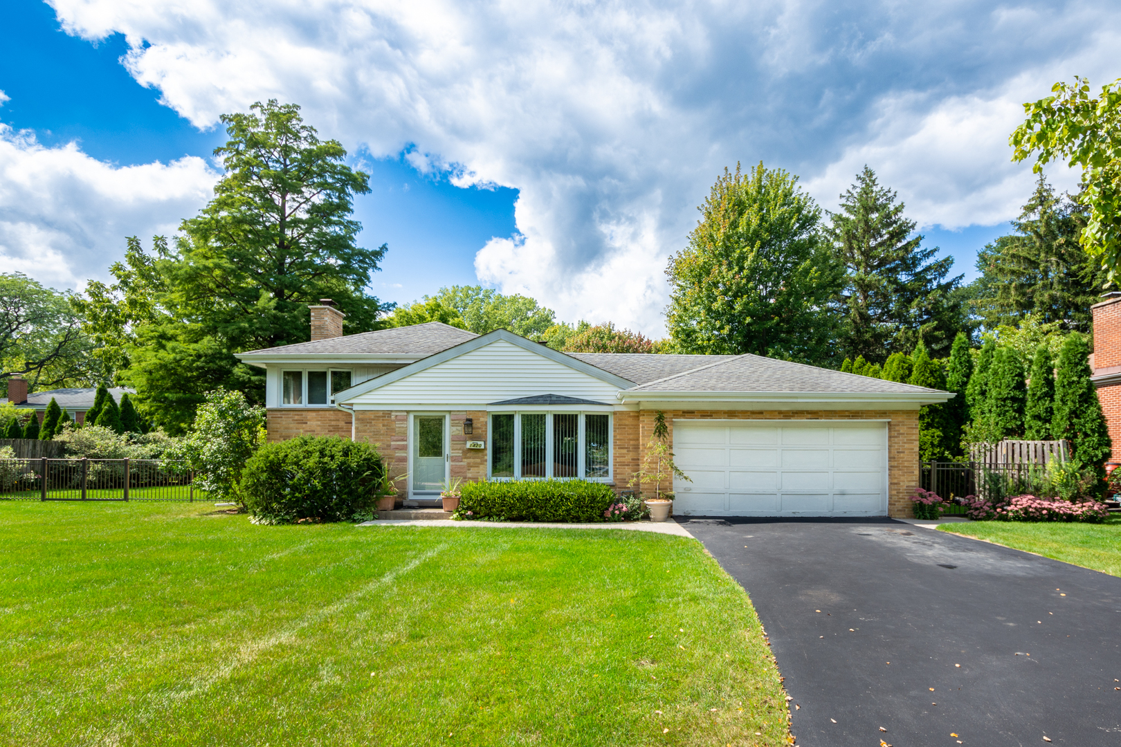 1420 Lee Road Northbrook, IL 60062 - Photo 2 of 36 a front view of a house with a garden