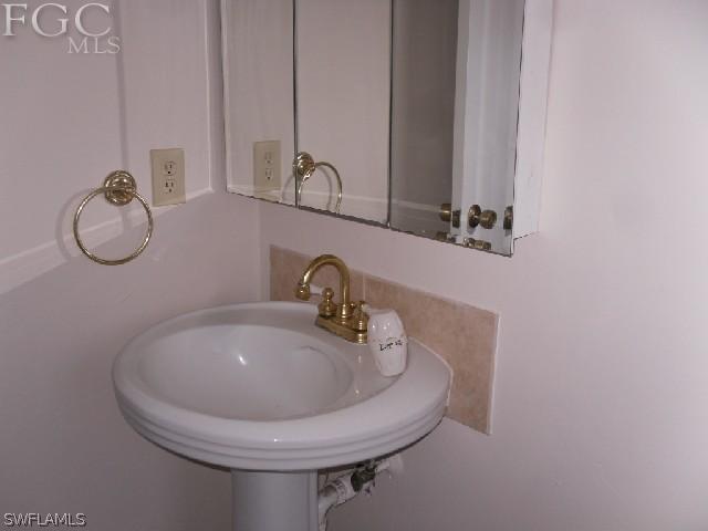9016 Morris Road Fort Myers, FL 33967 - Photo 6 of 12 a bathroom with a sink and a mirror