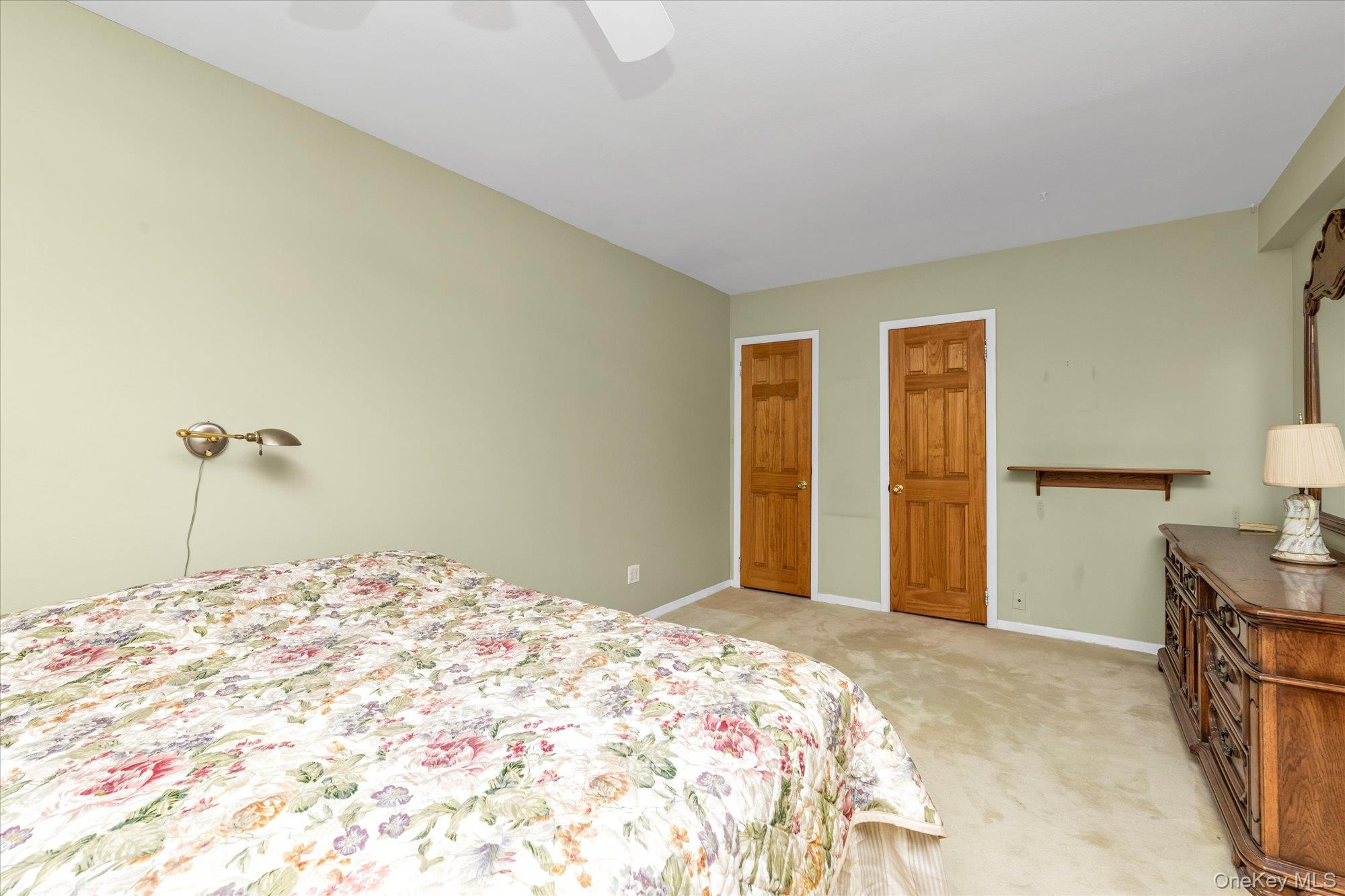 2 Fowler Avenue, Unit 228 Lynbrook, NY 11563 - Photo 12 of 18 a bedroom with a bed and a cabinets