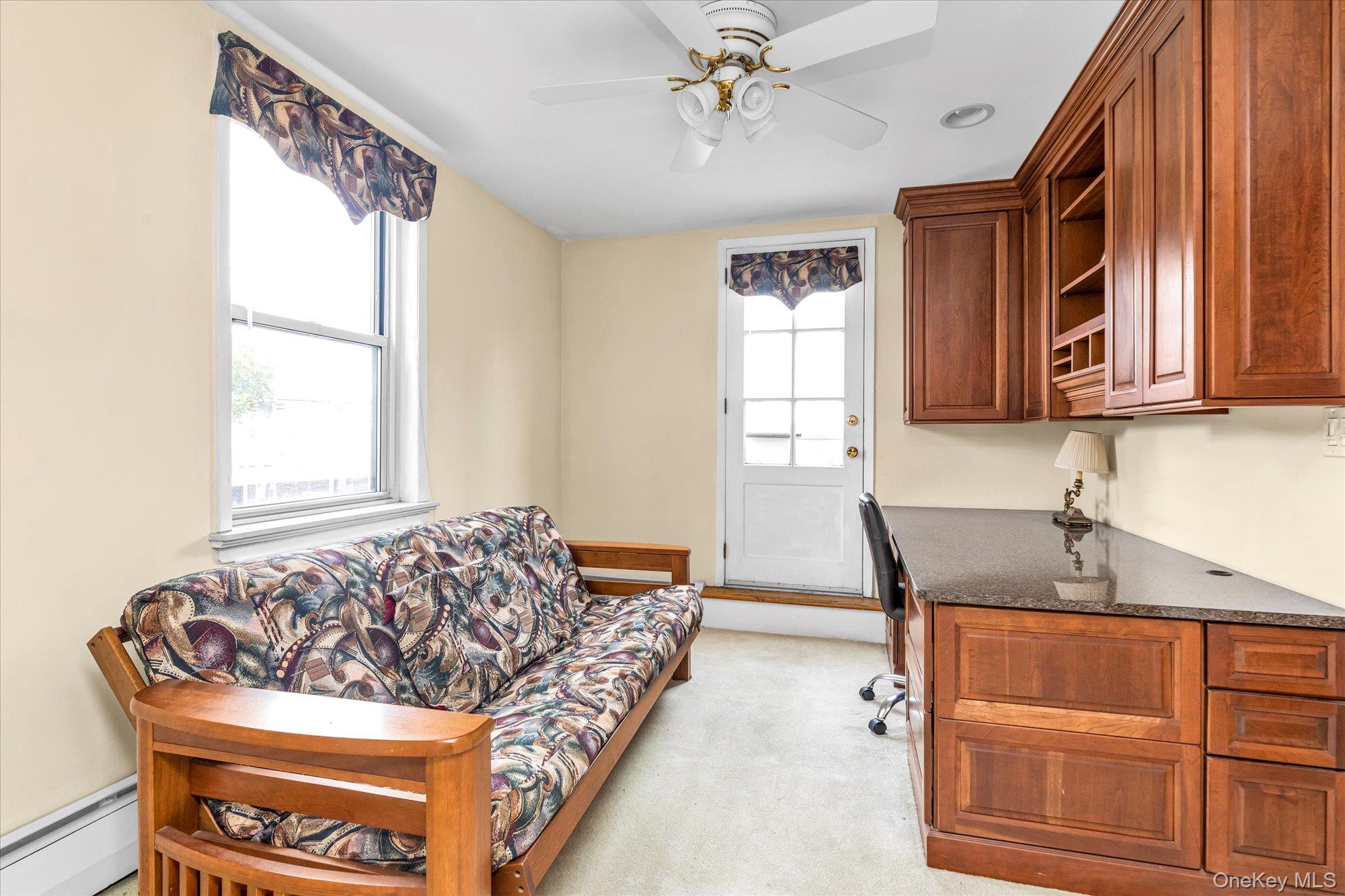 2 Fowler Avenue, Unit 228 Lynbrook, NY 11563 - Photo 13 of 18 a living room with furniture and a window