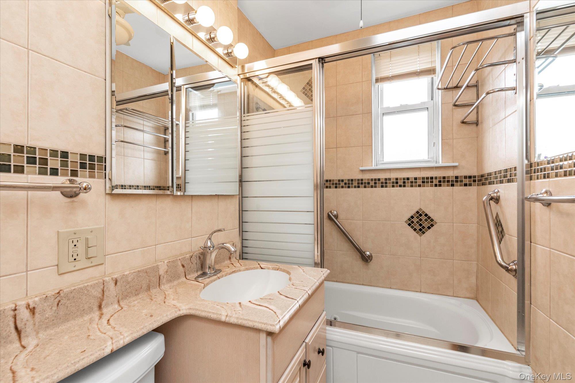2 Fowler Avenue, Unit 228 Lynbrook, NY 11563 - Photo 14 of 18 a bathroom with a sink and a bathtub