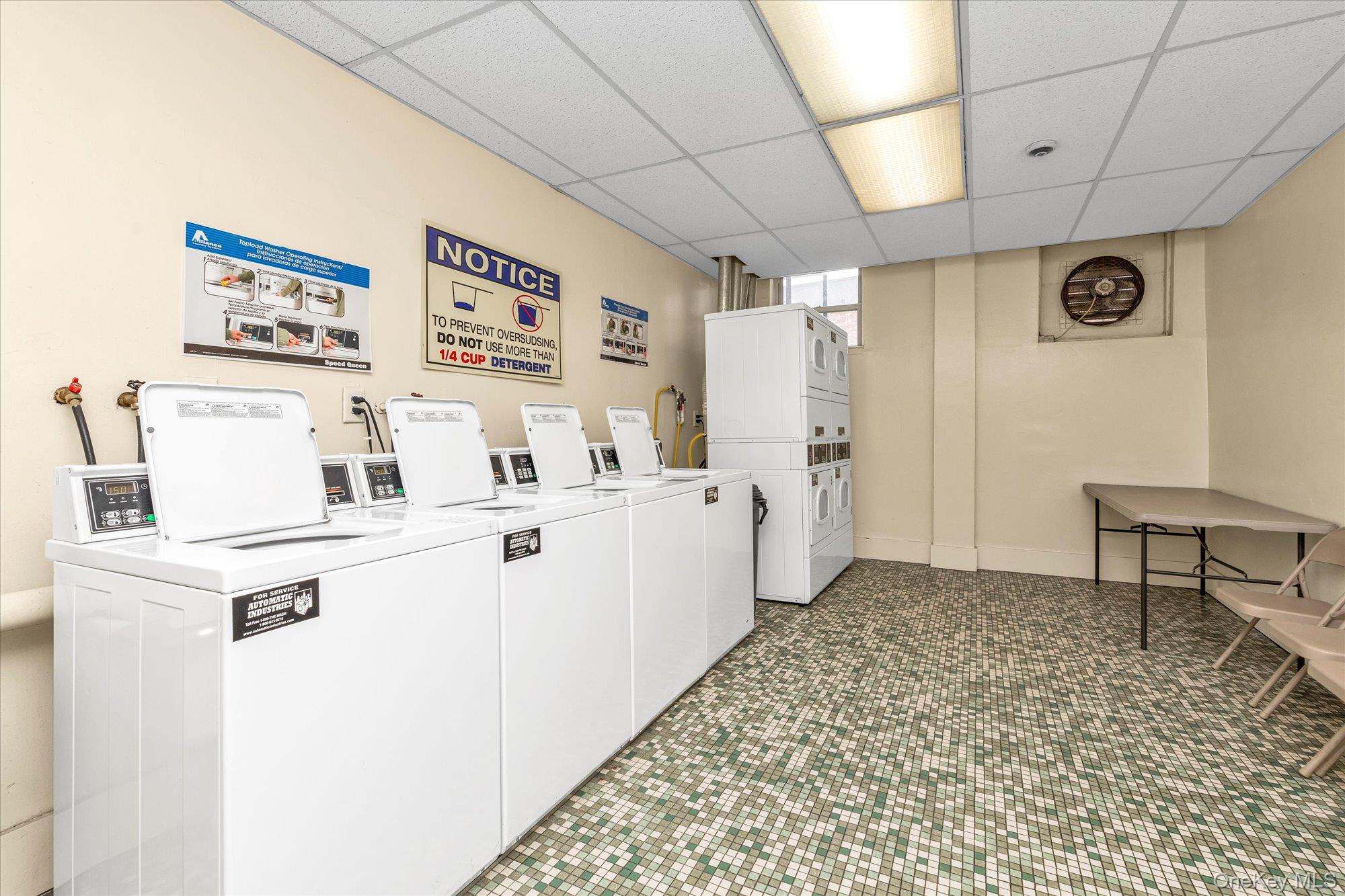 2 Fowler Avenue, Unit 228 Lynbrook, NY 11563 - Photo 16 of 18 a kitchen with a refrigerator and white cabinets