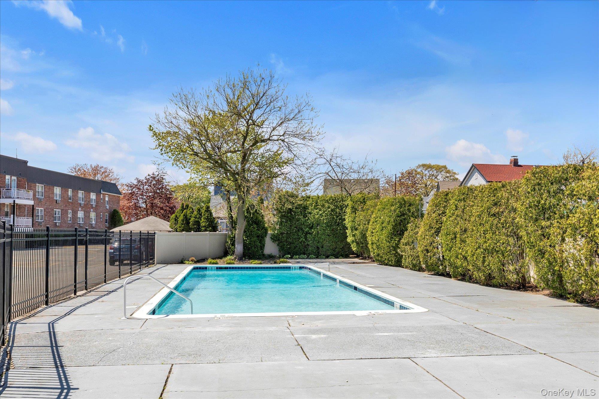 2 Fowler Avenue, Unit 228 Lynbrook, NY 11563 - Photo 17 of 18 a view of a patio with couches and table and chairs and potted plants