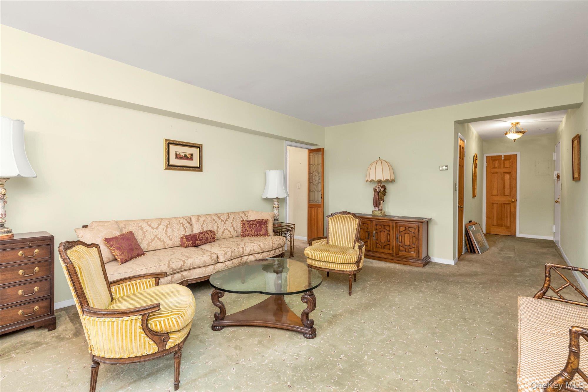 2 Fowler Avenue, Unit 228 Lynbrook, NY 11563 - Photo 5 of 18 a living room with furniture and a potted plant