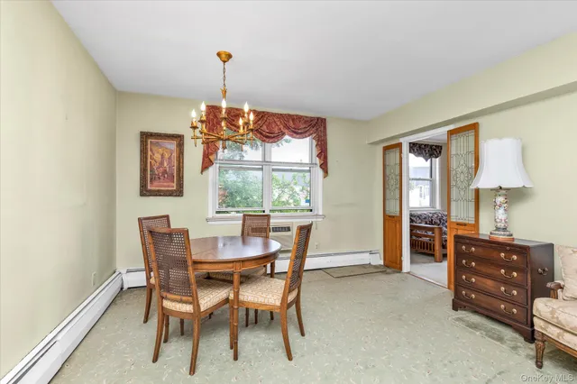 a dining room with furniture and window
