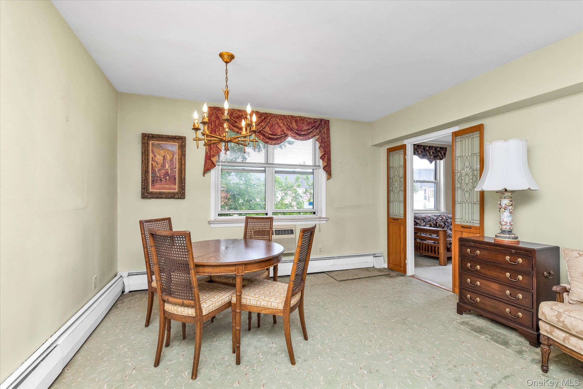 2 Fowler Avenue, Unit 228 Lynbrook, NY 11563 - Photo 6 of 18 a dining room with furniture and window