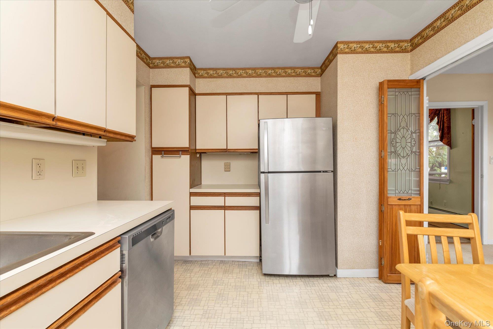 2 Fowler Avenue, Unit 228 Lynbrook, NY 11563 - Photo 7 of 18 a kitchen with stainless steel appliances a refrigerator and a stove