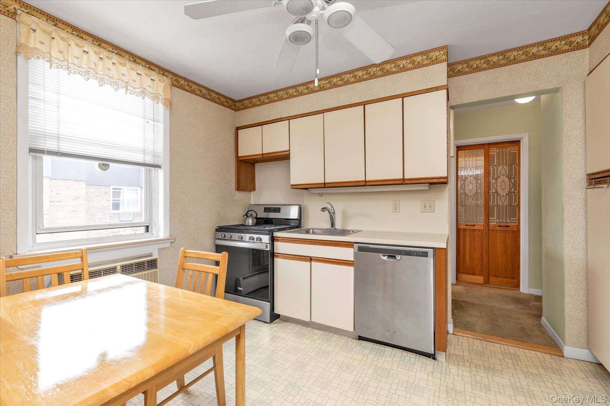 2 Fowler Avenue, Unit 228 Lynbrook, NY 11563 - Photo 8 of 18 a kitchen with stainless steel appliances granite countertop a stove a sink dishwasher and a refrigerator