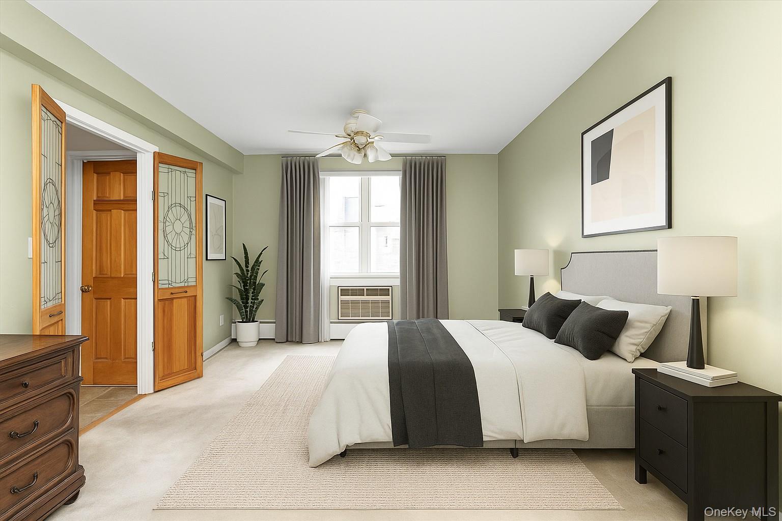 2 Fowler Avenue, Unit 228 Lynbrook, NY 11563 - Photo 10 of 18 a bedroom with a large bed and a window