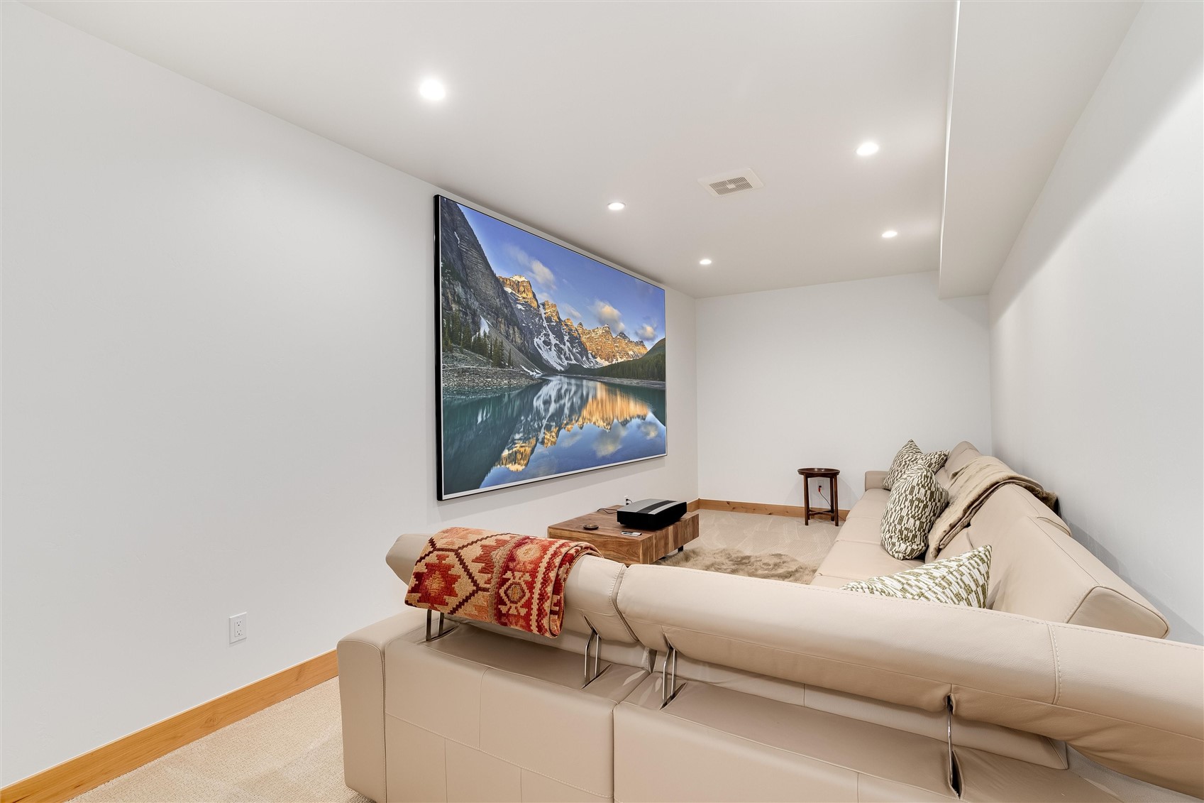 356 Angler Mountain Ranch Road Silverthorne, CO 80498 - Photo 26 of 35 Lower level flex space, owners created TV Room with 150in screen short throw projector.
