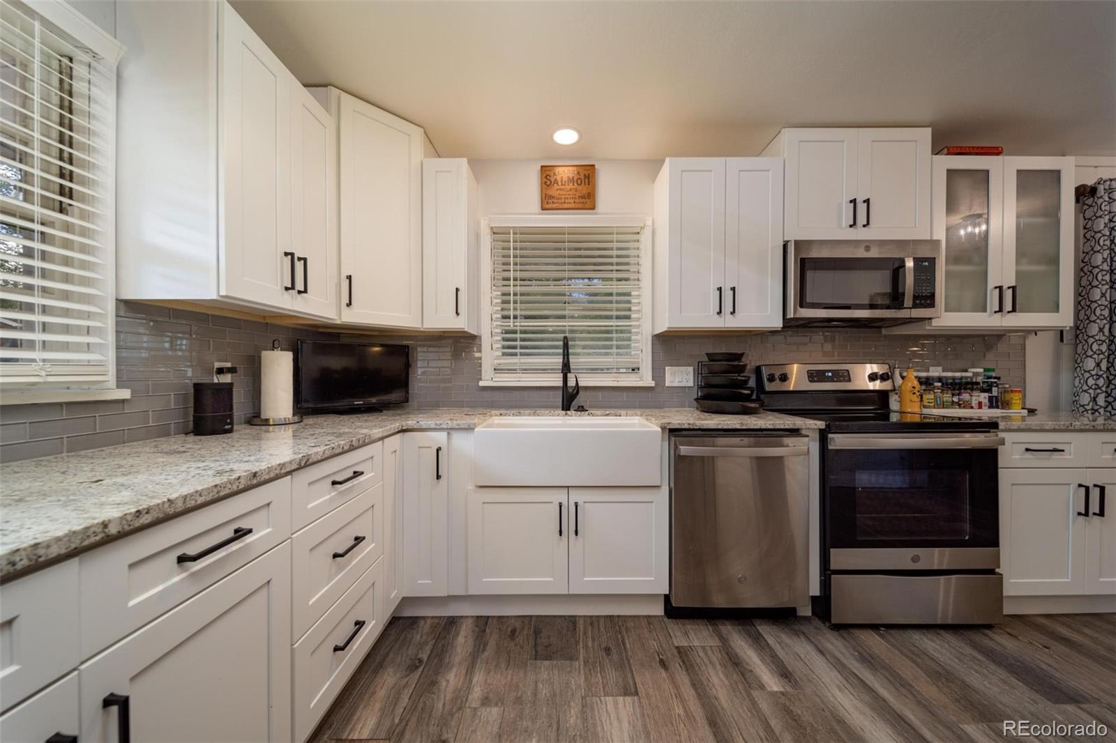 1749 North 15th Street Grand Junction, CO 81501 - Photo 14 of 23 a kitchen with stainless steel appliances granite countertop a stove a sink and a microwave