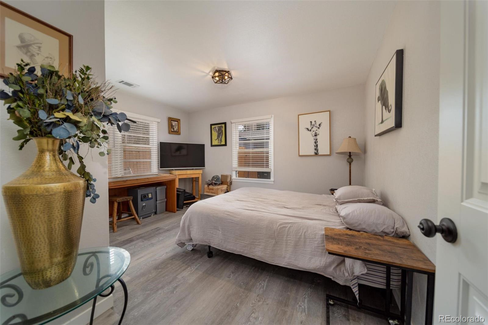 1749 North 15th Street Grand Junction, CO 81501 - Photo 20 of 23 a bedroom with a bed a couch and a potted plant on the dresser