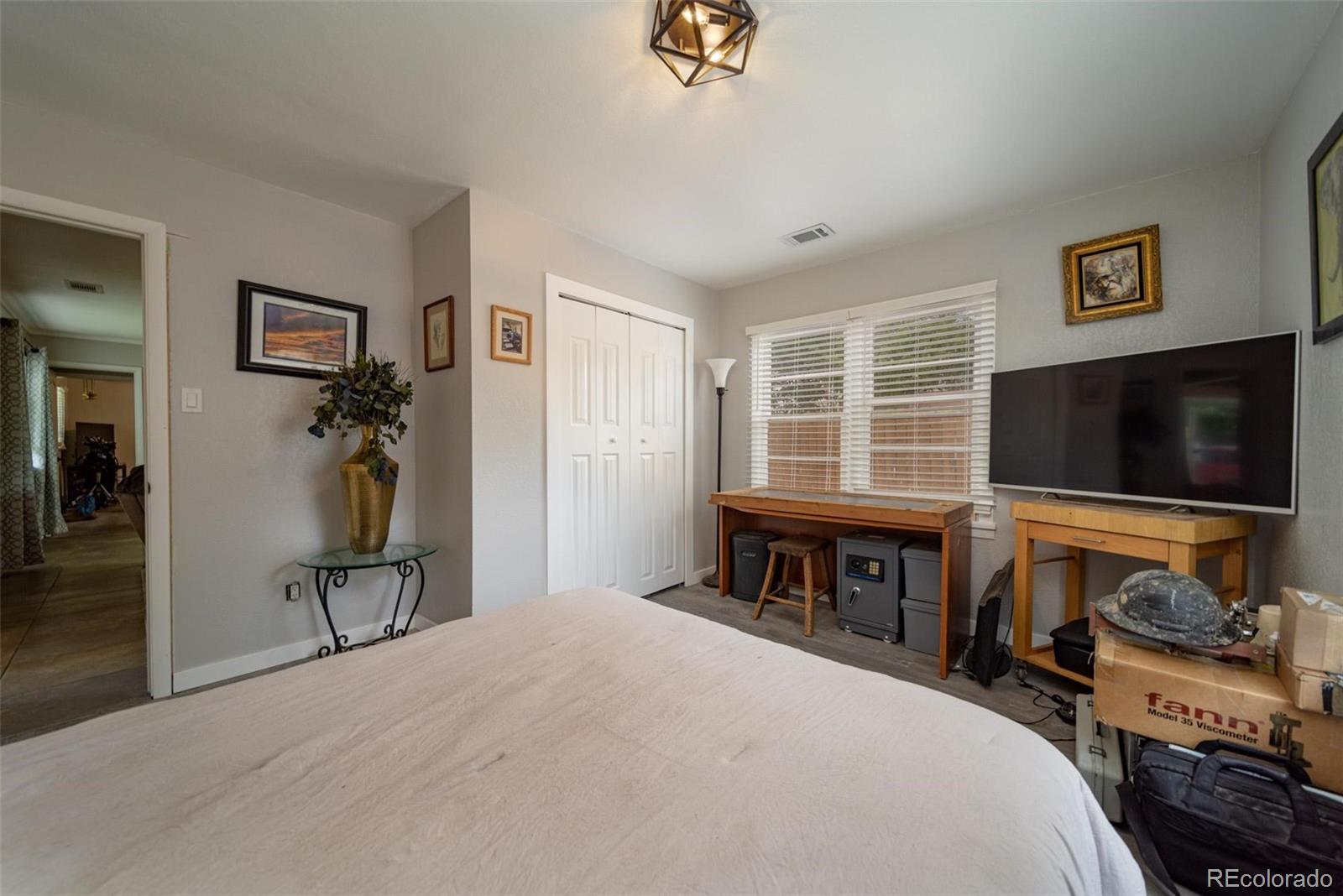 1749 North 15th Street Grand Junction, CO 81501 - Photo 21 of 23 a bedroom with furniture and a flat screen tv