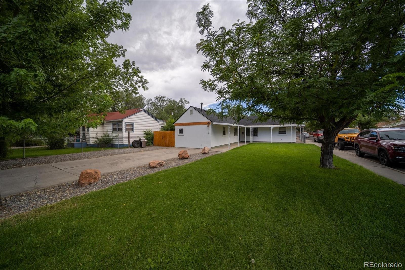 1749 North 15th Street Grand Junction, CO 81501 - Photo 3 of 23 a front view of a house with a yard