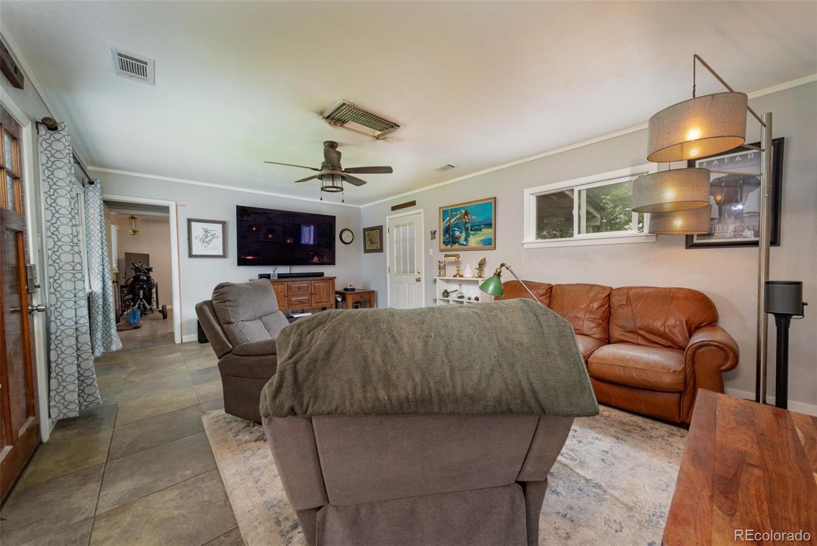 1749 North 15th Street Grand Junction, CO 81501 - Photo 10 of 23 a living room with furniture and a chandelier