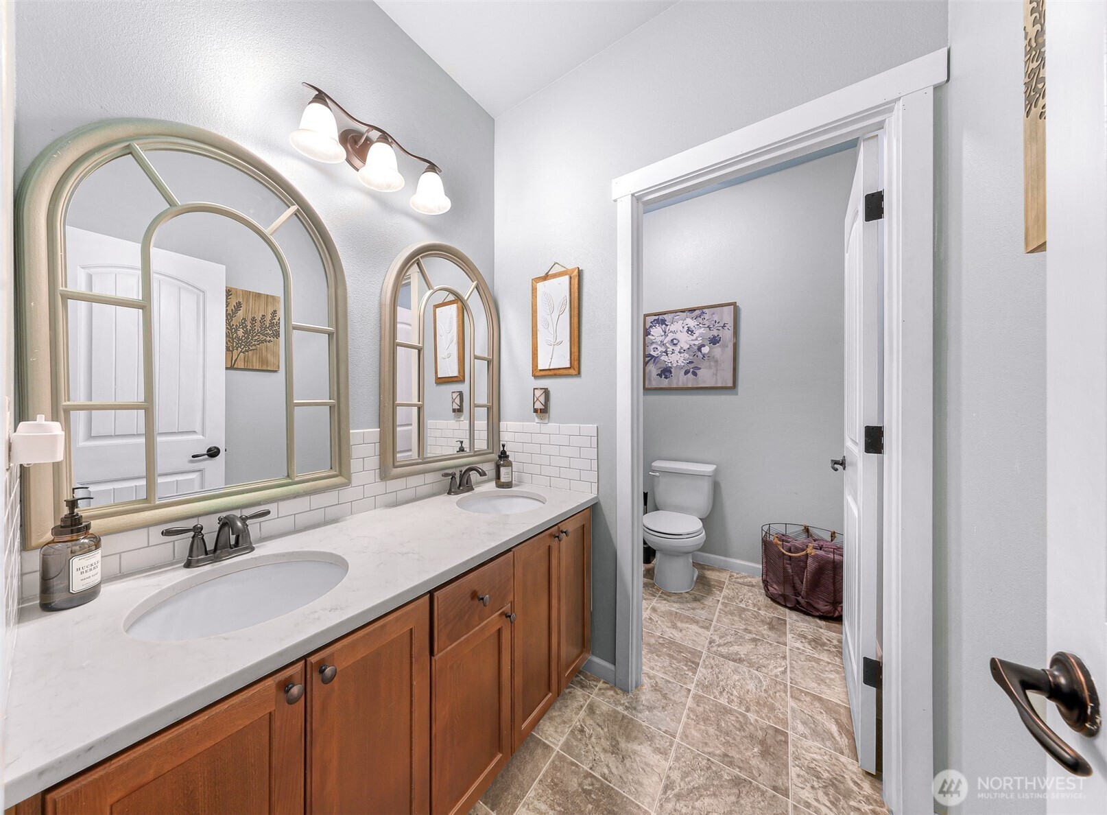 19727 Skyridge Road Mount Vernon, WA 98274 - Photo 16 of 32 a spacious bathroom with a granite countertop sink a toilet and a mirror