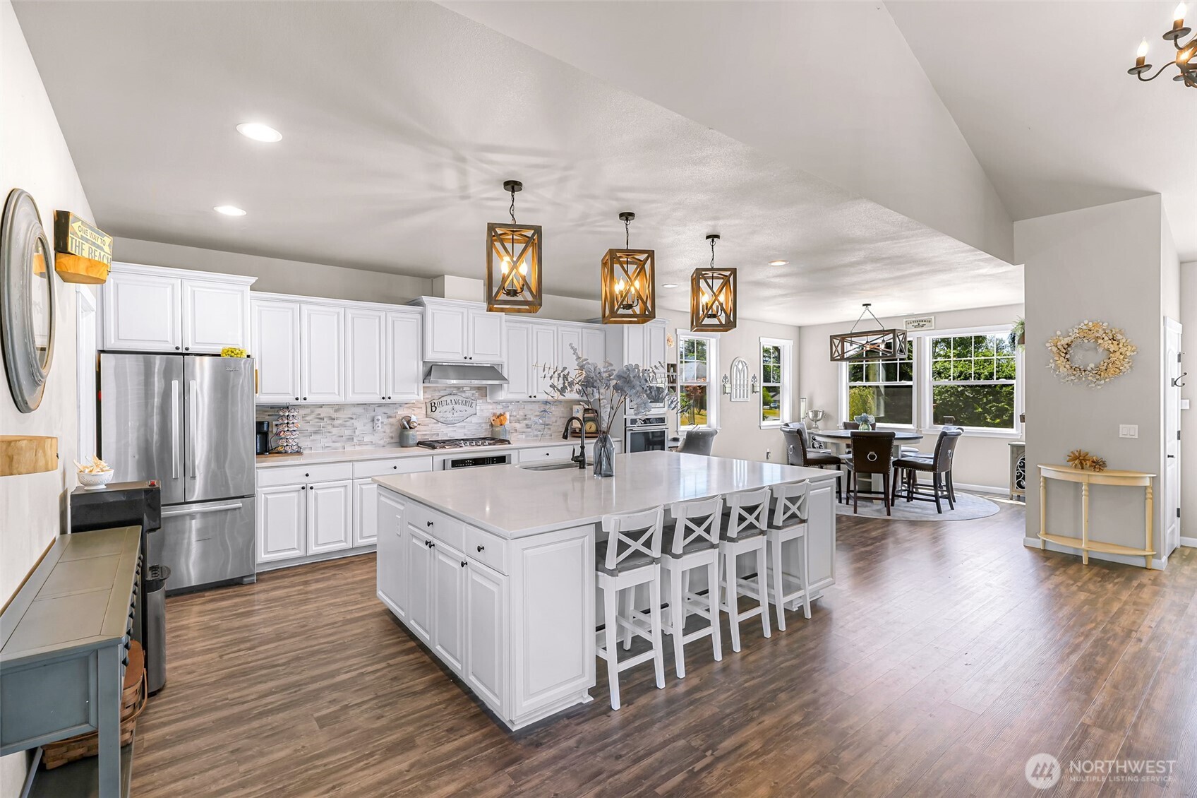 19727 Skyridge Road Mount Vernon, WA 98274 - Photo 7 of 32 a large white kitchen with lots of counter space a dining table and chairs