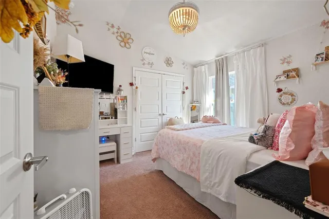 a bedroom with a bed and flat screen tv