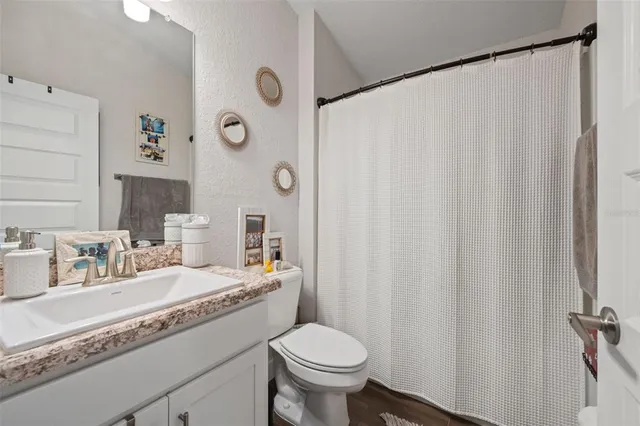 a bedroom with a bed next to a large window with a flat screen tv