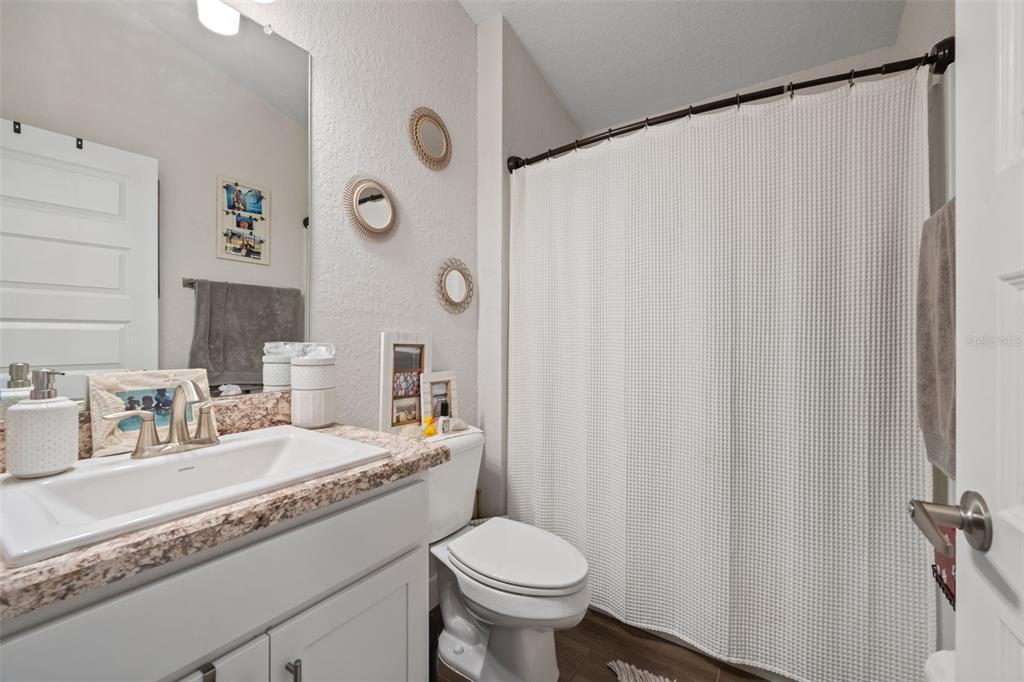 199 Bittern Loop Inverness, FL 34453 - Photo 15 of 36 a bathroom with a granite countertop sink and a toilet