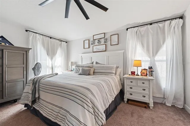 a bedroom with a large bed and a chandelier