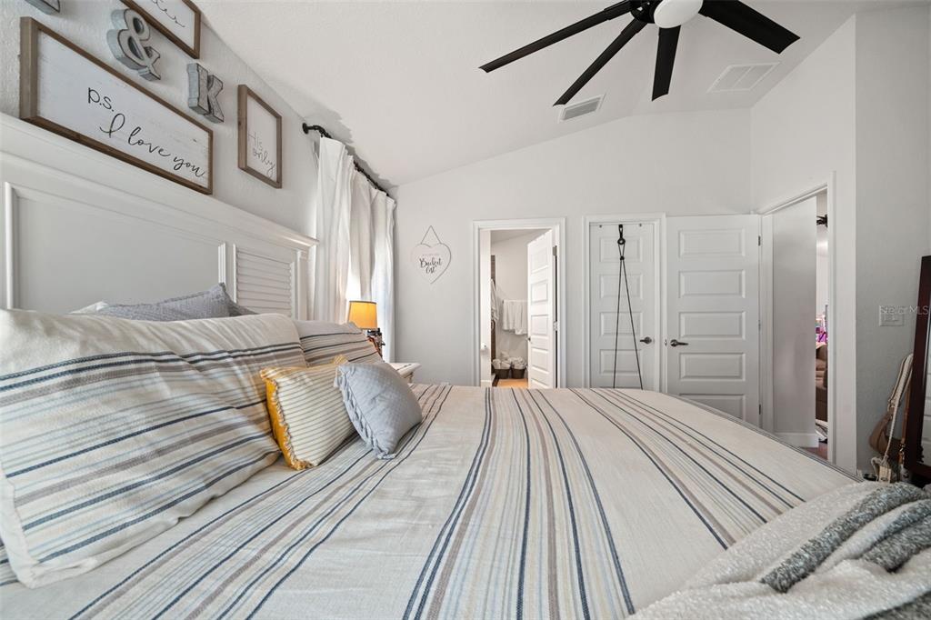 199 Bittern Loop Inverness, FL 34453 - Photo 19 of 36 a bedroom with a large bed and a chandelier