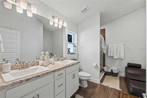 a bathroom with a bathtub a sink and a chair