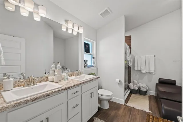 a bathroom with a bathtub a sink and a chair