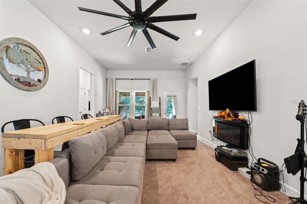199 Bittern Loop Inverness, FL 34453 - Photo 23 of 36 a living room with furniture and a flat screen tv