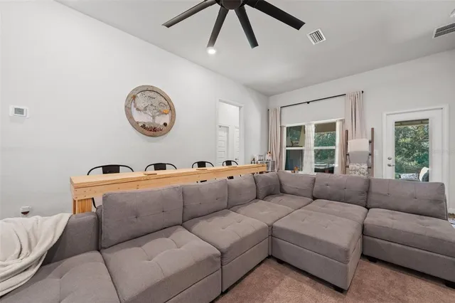 a view of a livingroom with furniture and a flat screen tv