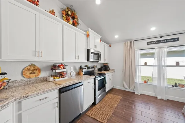 a dining room with furniture and wooden floor