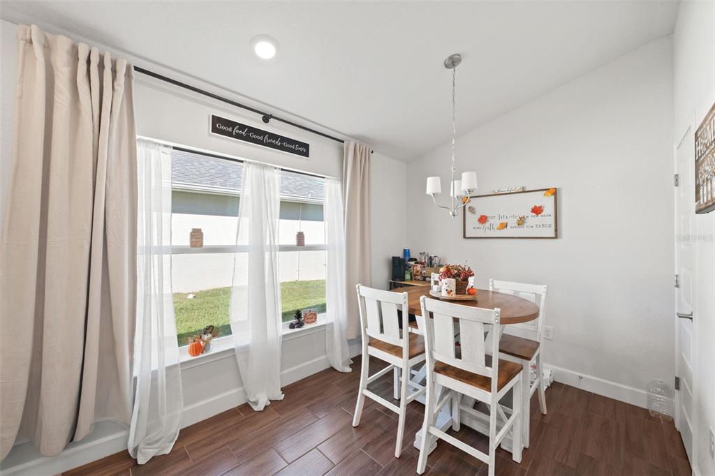 199 Bittern Loop Inverness, FL 34453 - Photo 29 of 36 a dining room with furniture and wooden floor