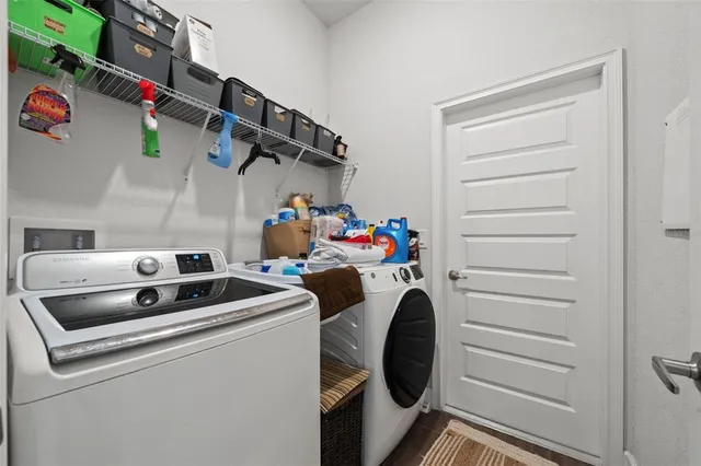 an aerial view of a house with swimming pool and large trees
