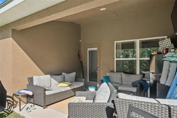 a view of a backyard with furniture and a garden