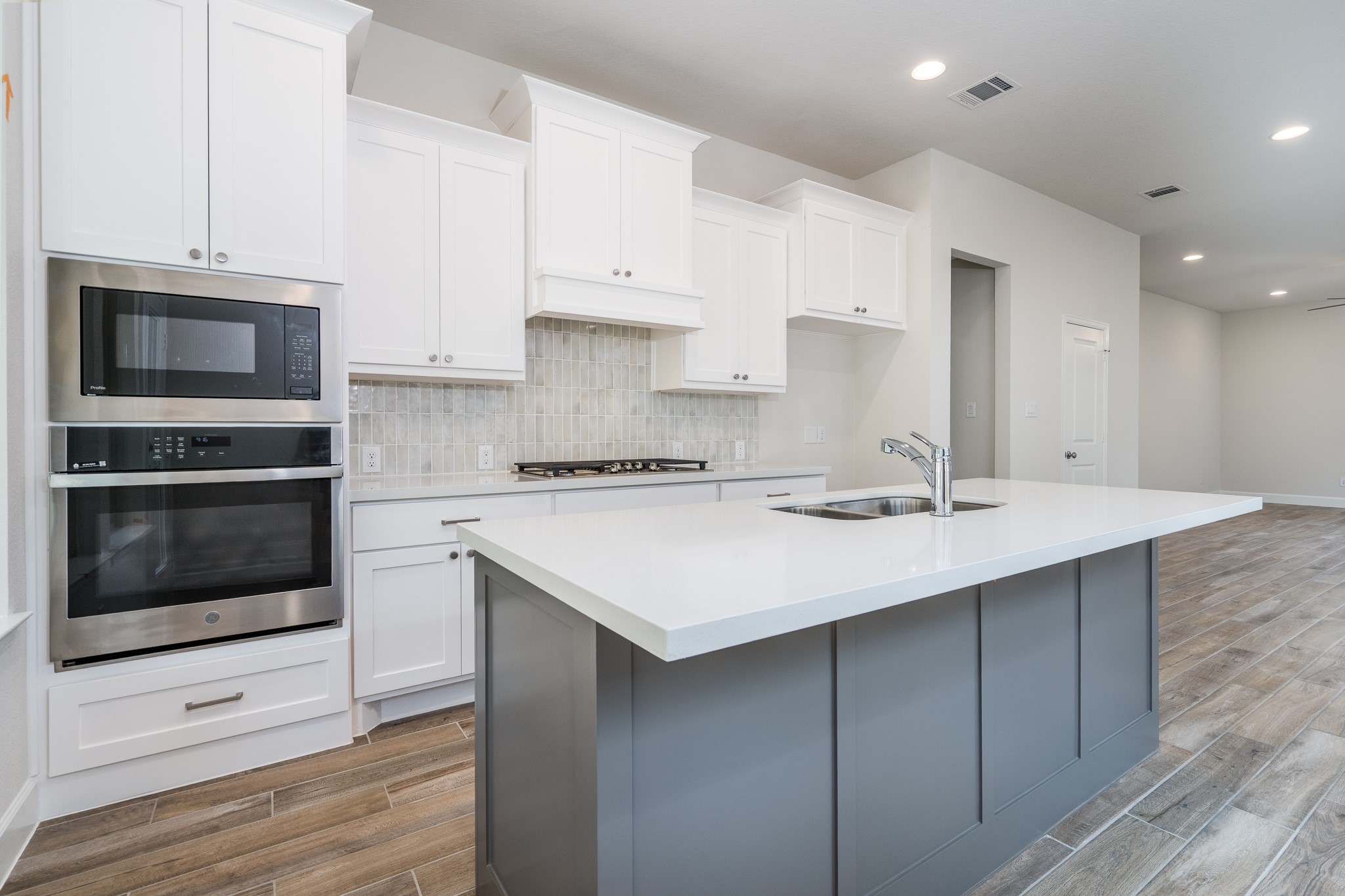30314 Ruby Frst Court Magnolia, TX 77354 - Photo 12 of 29 a kitchen with stainless steel appliances a stove a sink and a microwave