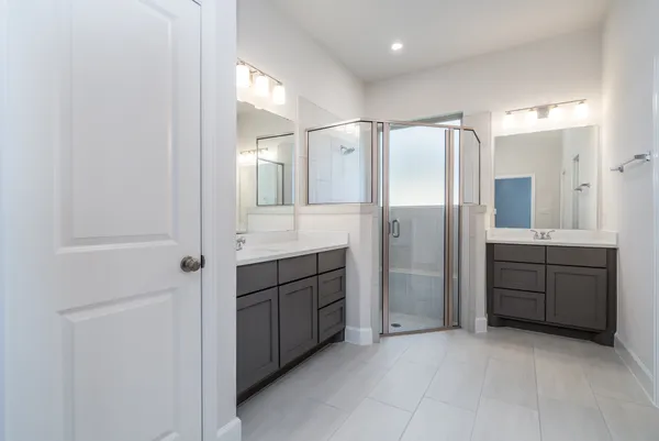 a bathroom with a granite countertop sink mirror and shower