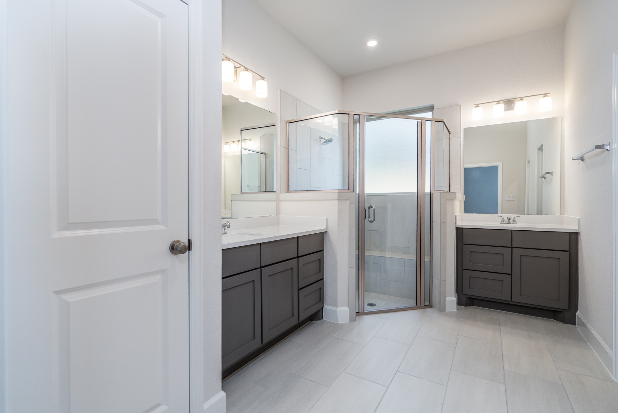 30314 Ruby Frst Court Magnolia, TX 77354 - Photo 17 of 29 a bathroom with a granite countertop sink mirror and shower