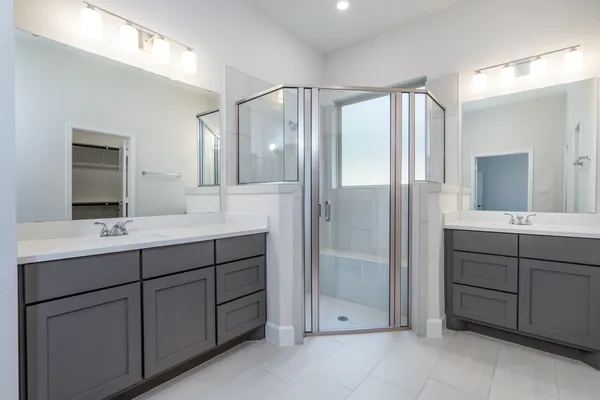 a bathroom with a double vanity sink mirror and double