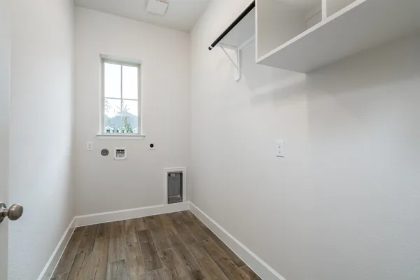 a view of a room with wooden floor and windows