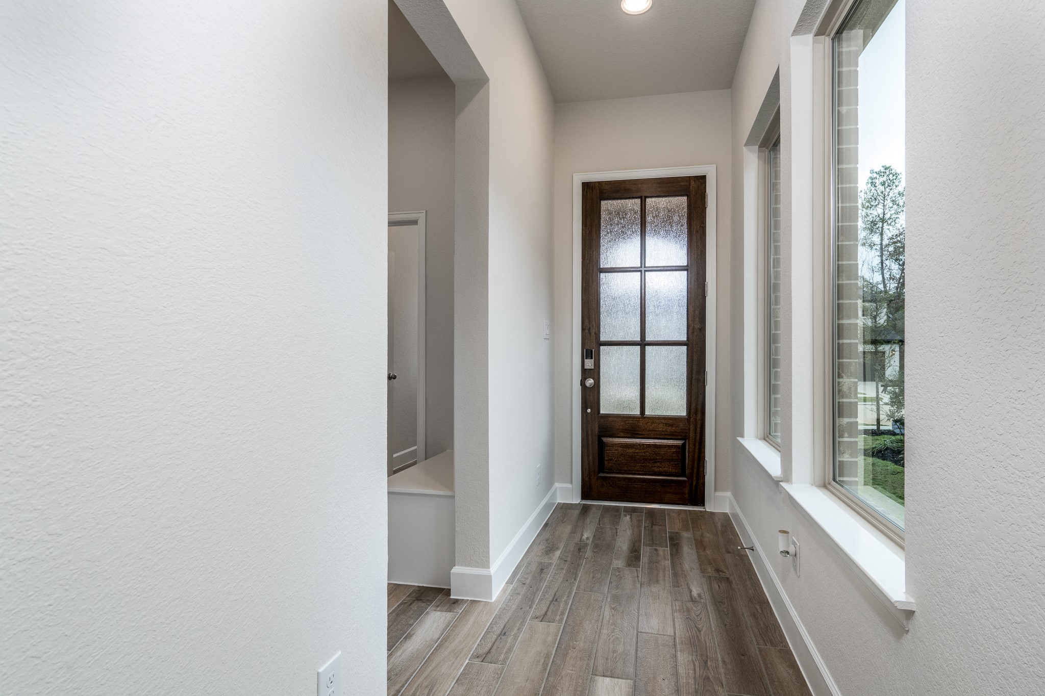 30314 Ruby Frst Court Magnolia, TX 77354 - Photo 5 of 29 a view of an empty room with wooden floor and windows