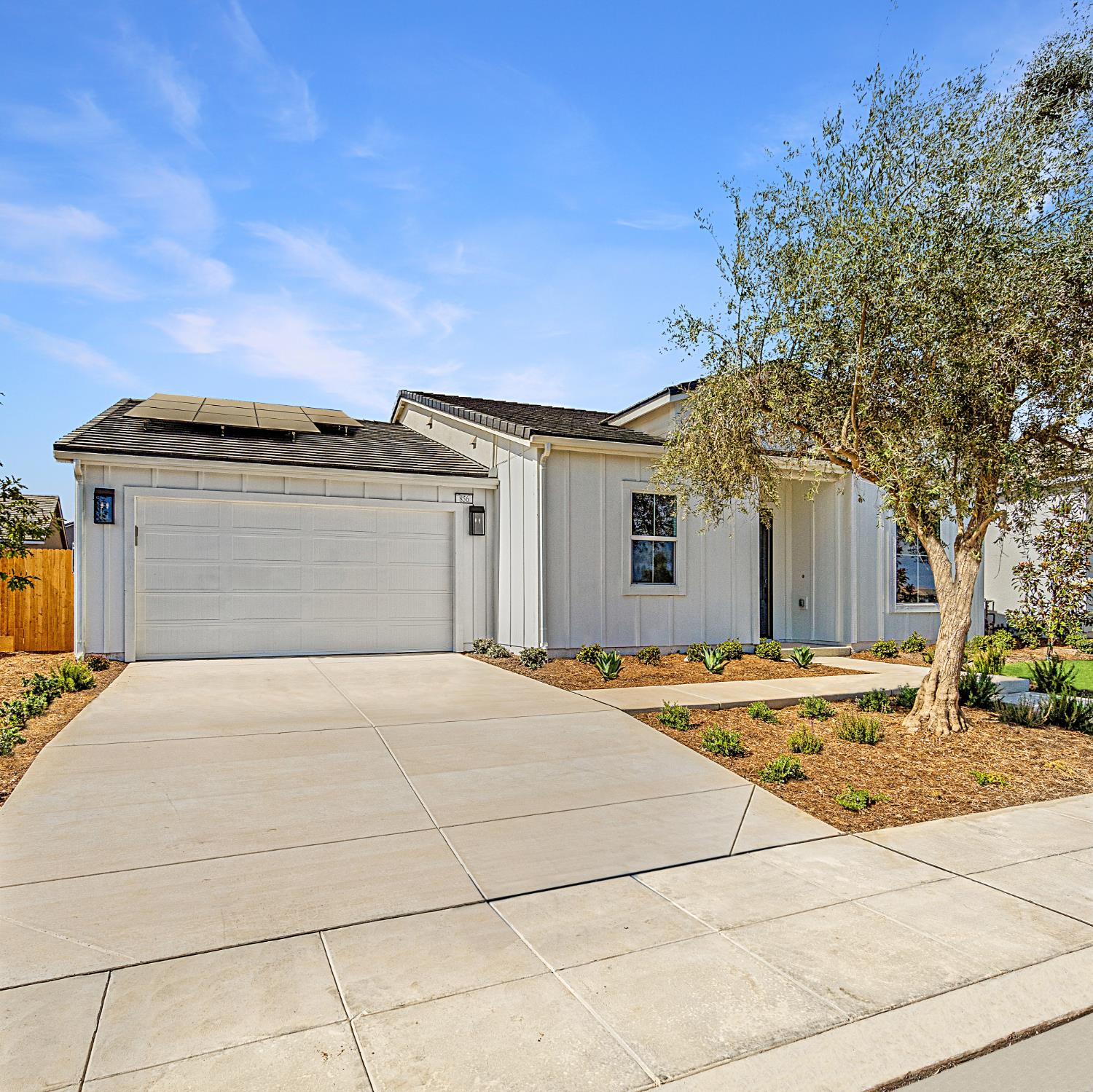 856 Traverse Drive Madera, CA 93636 - Photo 3 of 34 a front view of a house with a yard and garage