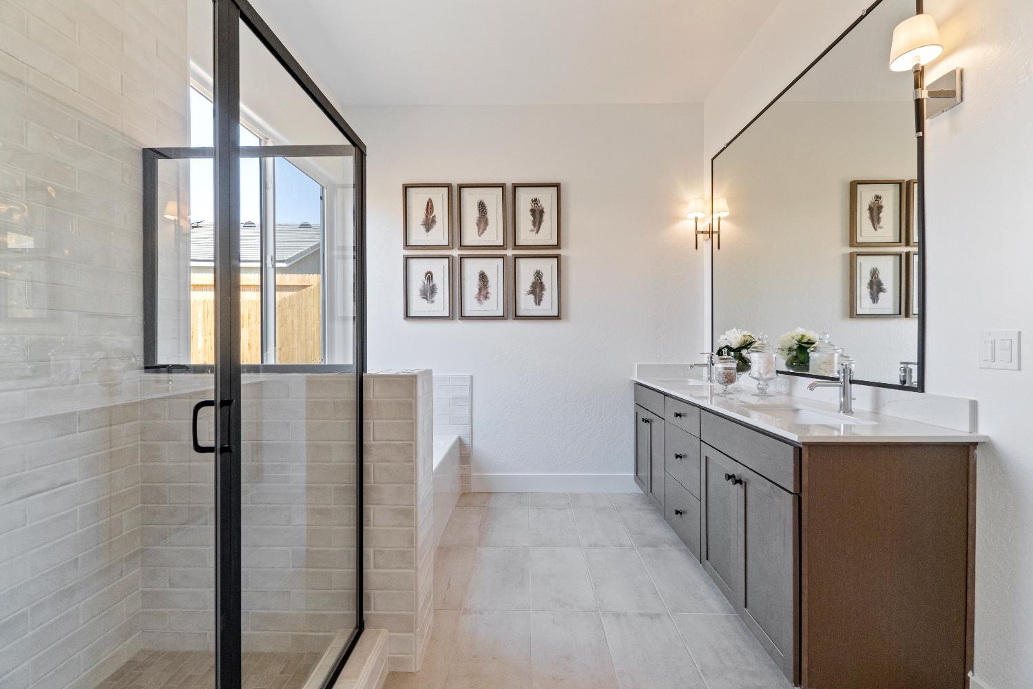 856 Traverse Drive Madera, CA 93636 - Photo 32 of 34 a bathroom with a granite countertop sink a mirror and a shower