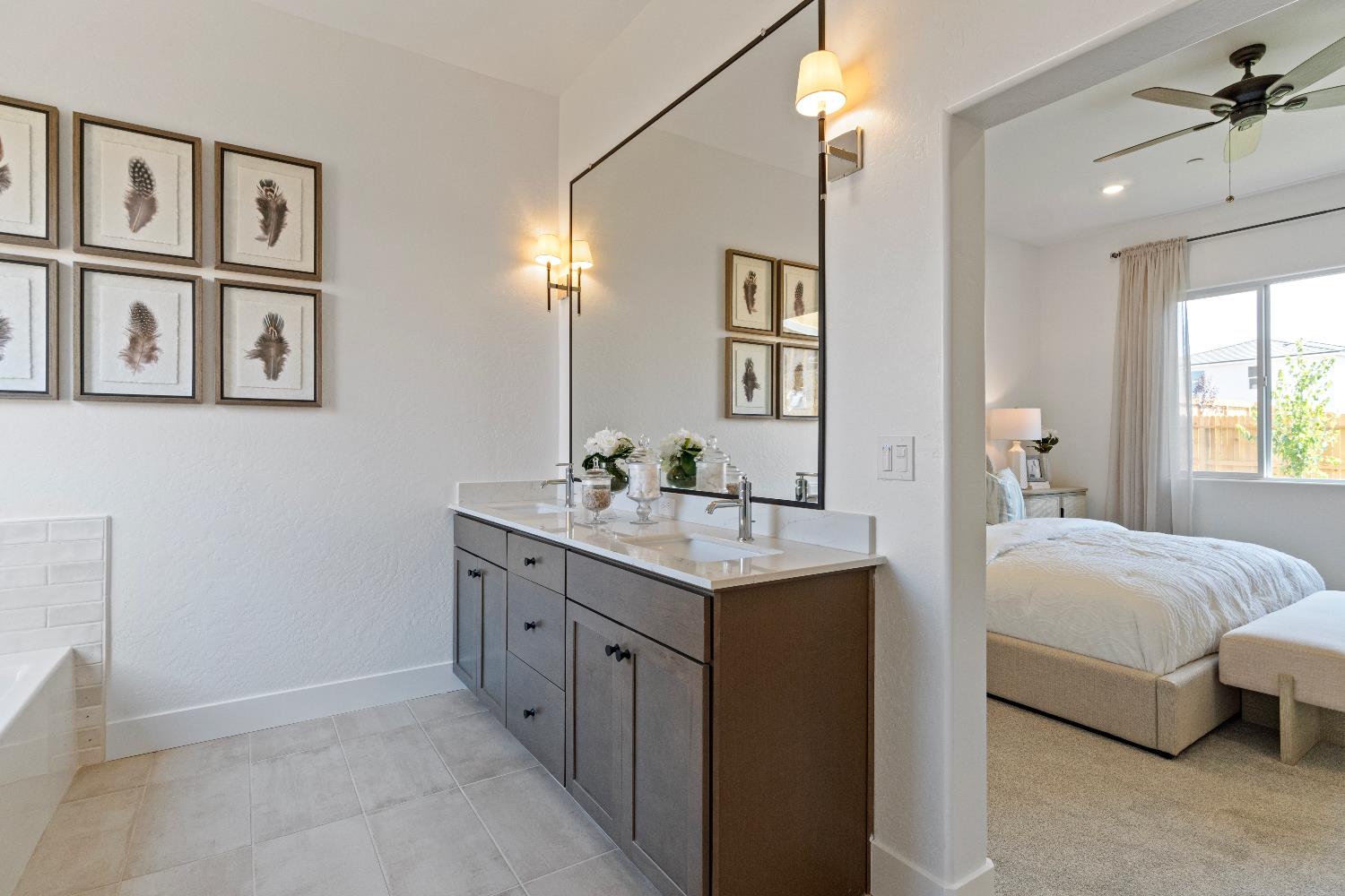 856 Traverse Drive Madera, CA 93636 - Photo 33 of 34 a en suite bathroom with a double vanity sink a mirror and a bathtub