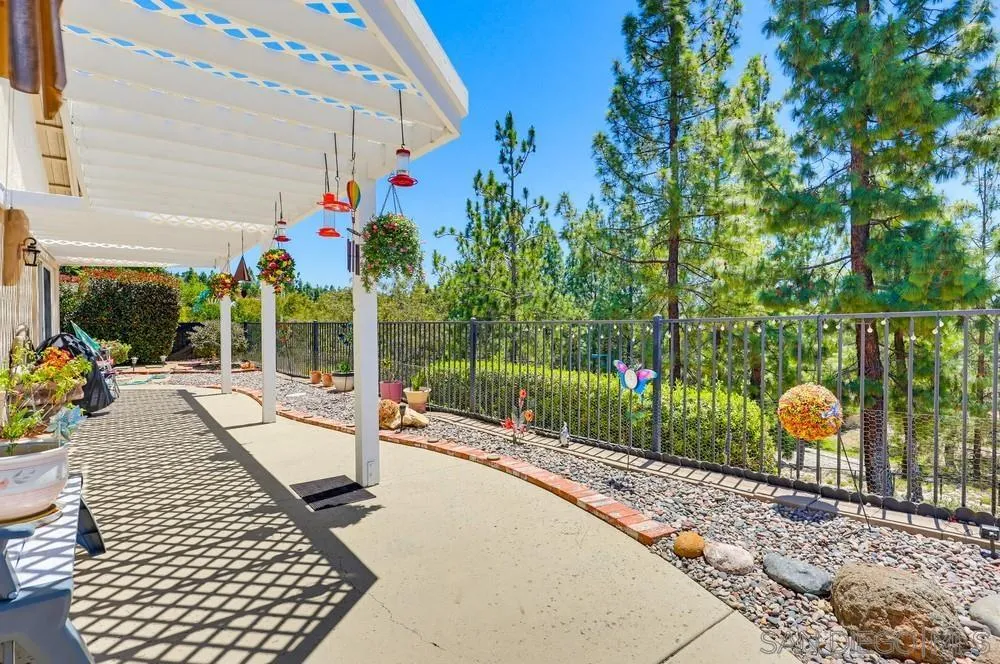 2501 Columbine Road Alpine, CA 91901 - Photo 38 of 44 a view of a patio with a table chairs and a backyard