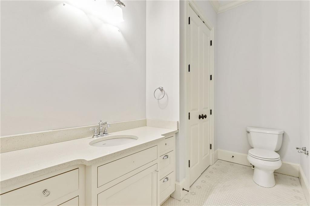 4227 Peachtree Dunwoody Road Atlanta, GA 30342 - Photo 33 of 44 a spacious bathroom with a toilet sink and mirror