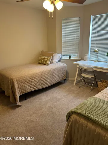 a bedroom with a bed a lamp and a window