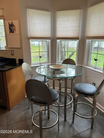 a view of a dining room with furniture and window